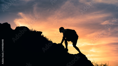 Man climbing hiking up a mountain edge 