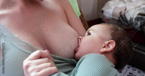 mother breastfeeding baby at home. motherhood and maternity care concept. Cheerful mom enjoy breastfeeding