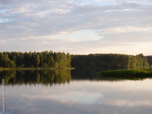 landscape with reflection in the water . Beautiful sunset over a calm lake After sunset, the sky is reflected in the water
