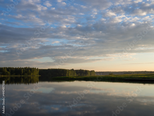landscape with reflection in the water . Beautiful sunset over a calm lake After sunset, the sky is reflected in the water