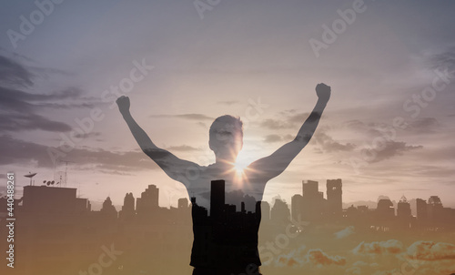 Confident young man with fist in the air facing the city. People power and feeling strong concept	