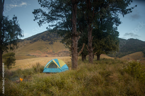 Camping with hills in the background.