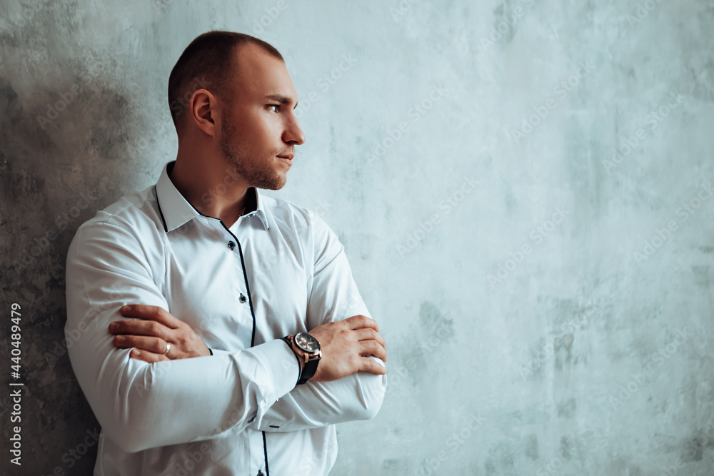Man standing near concrete wall crossed arms watches on wrist looking away thinking. Groom dressed wear white shirt official photoshoot marriage day wedding ring on finger, luxury copyspace Man standing near concrete wall crossed arms watches on wrist looking away thinking. Groom dressed wear white shirt official photoshoot marriage day wedding ring on finger, luxury copyspace
