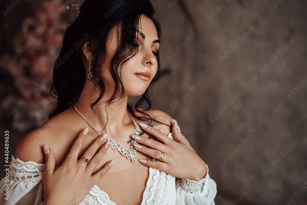 Close up female married bride celebrate engagement. Woman dressed white dress silver necklace with diamonds touching body. Procreation romantic amazing lady indoor, copy space.
