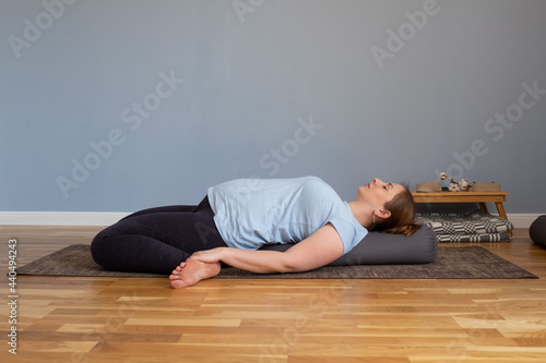 Reclining Hero Pose or Supta Virasana. Pregnant woman resting in yoga asana