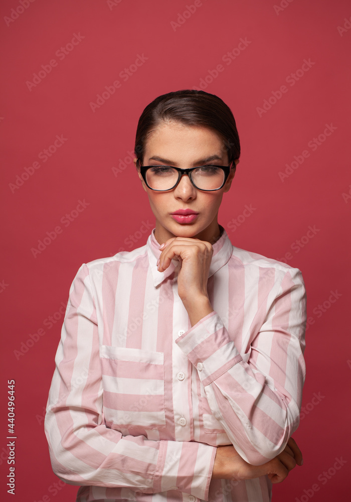 Smart confident woman in glasses on red background Smart confident woman in glasses on red background