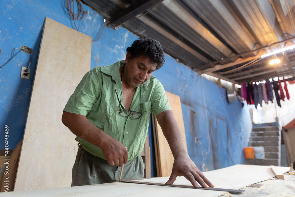 Mexican woodworker, carpenter working in his workshop