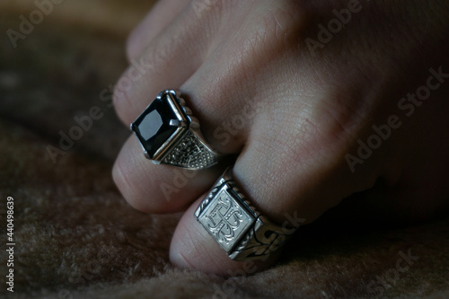 silver rings, one signet style and one with gold and onyx