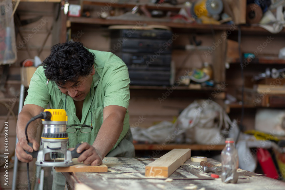 Mexican woodworker, carpenter working in his workshop Mexican woodworker, carpenter working in his workshop
