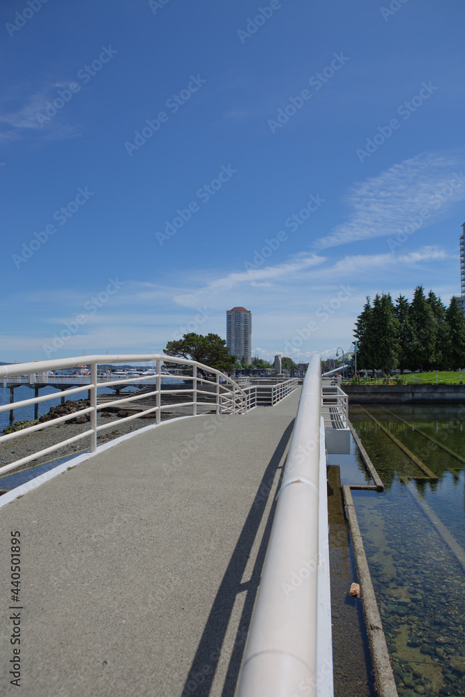 A beautiful view of footbridge Maffeo Sutton Park in Nanaimo to downtown city center
