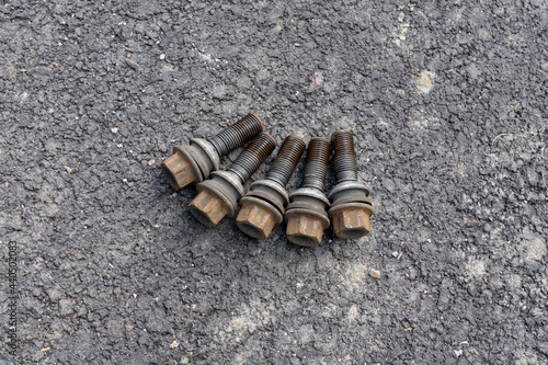 Car Wheel bolts on asphalt.