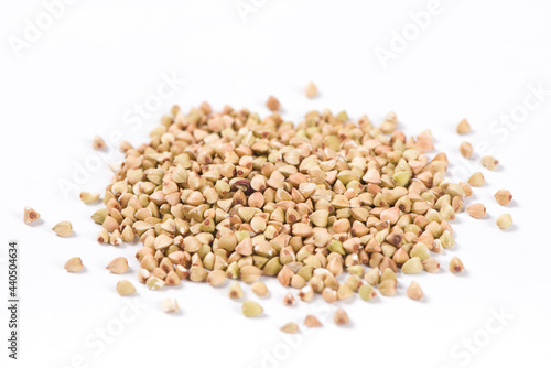 Pile of raw buckwheat isolated on white background.