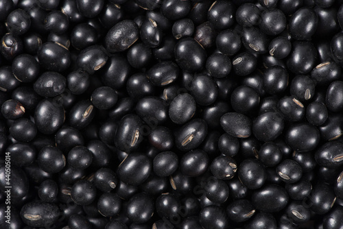 Close-up raw black soya bean textured background.