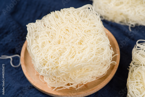 died rice noodles on wooden background