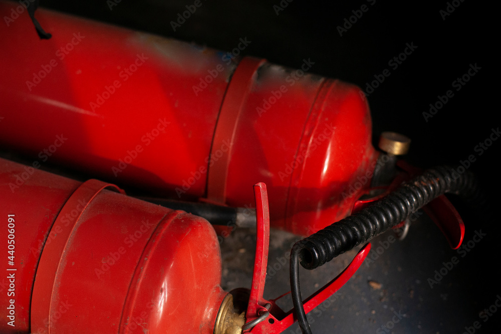 The fire extinguisher is red. A means of protection against fire.