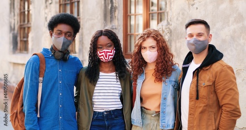 Our unity. Company of best friends wearing protective masks spending time together at the city during the covid 19 pandemic. Quarantine concept