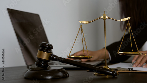 Lawyers work with contract documents and hammer with scales and laptops on the courtroom table. justice and law court judge concept