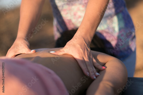 female fingers giving massage to a woman's back © PAVEL