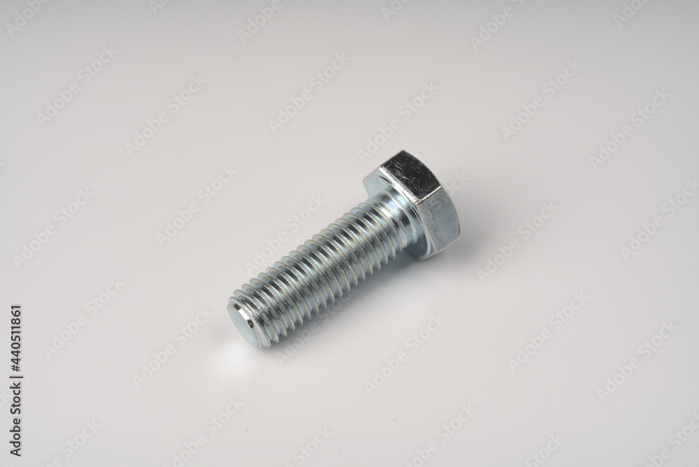 Metal large bolt with thread on white background.