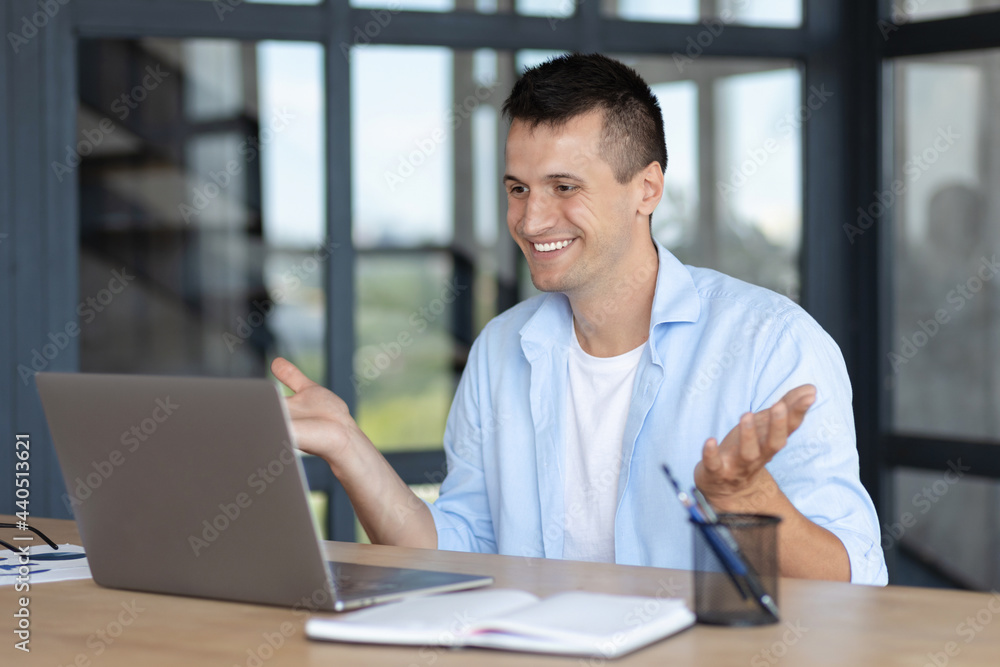 Successful young caucasian manager man using laptop for video communication with employees. Video conferencing or online education concept Successful young caucasian manager man using laptop for video communication with employees. Video conferencing or online education concept