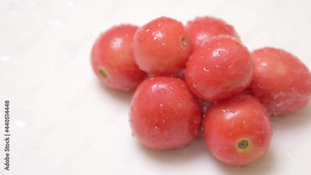 Water particles on small amount of cherry tomatoes Water particles on small amount of cherry tomatoes