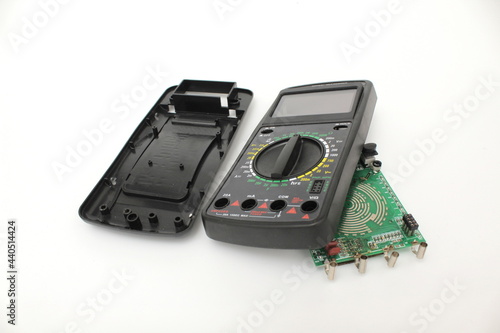 Broken digital multimeter isolated on white background