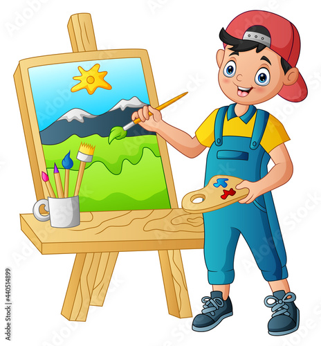 Boy painting a landscape on the canvas