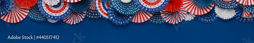 Vibrant red white and blue paper fans banner with space for text. For 4th of July, Memorial day, Veteran's day, or other patriotic holiday celebrations.