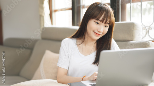 Free Download Happy young adult asian student woman study online via internet at home indoor on day. - GFXLoad