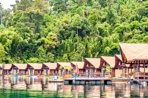 Resort wooden home raft floating and mountain fog on river kwai at Khao Sok National Park, Surat Thani Province, Thailand. Concept image for transportation,boat,nature,scenery,travel,outdoor