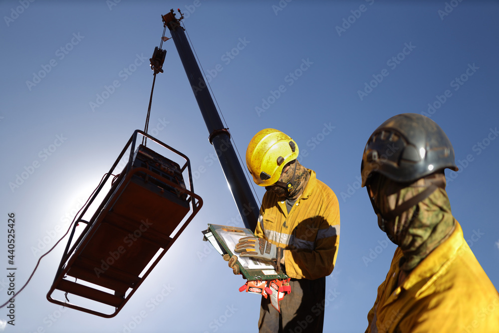 Senior site safety auditor supervisor wearing safety helmet verifying