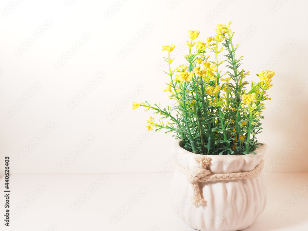 Picture of artificial plastic flower on a ceramic vase
