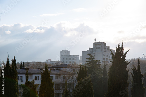 Clouds over buildings hiding mountains in the spring in the city of Alushta in the Crimea.