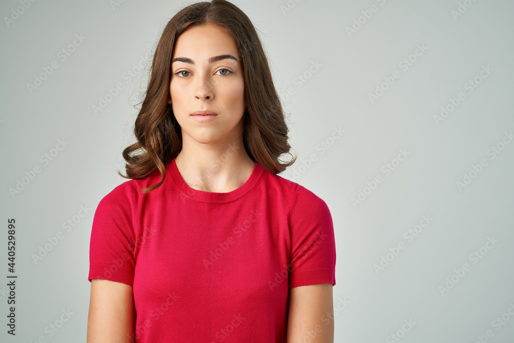 pretty brunette in red t-shirt posing fashion studio pretty brunette in red t-shirt posing fashion studio