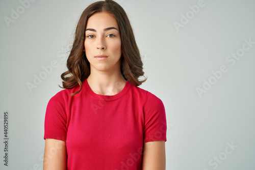 pretty brunette in red t-shirt posing fashion studio