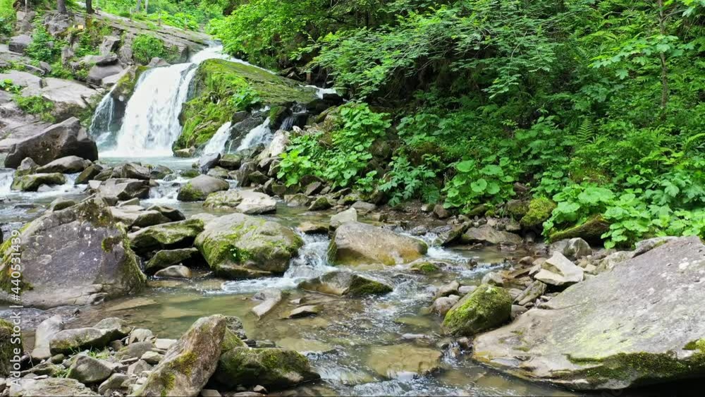 mountain river waterfall flowing between rocky shores in Carpathians mountains, Ukraine mountain river waterfall flowing between rocky shores in Carpathians mountains, Ukraine