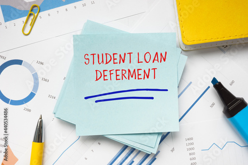 Financial concept about STUDENT LOAN DEFERMENT with sign on the piece of paper. photo