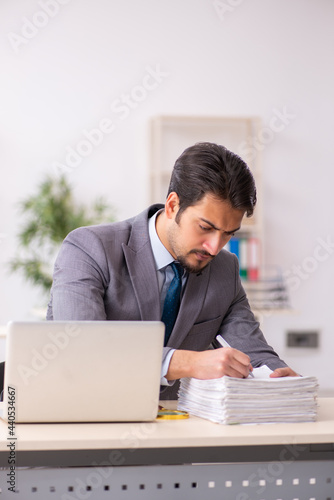 Young male employee working in the office