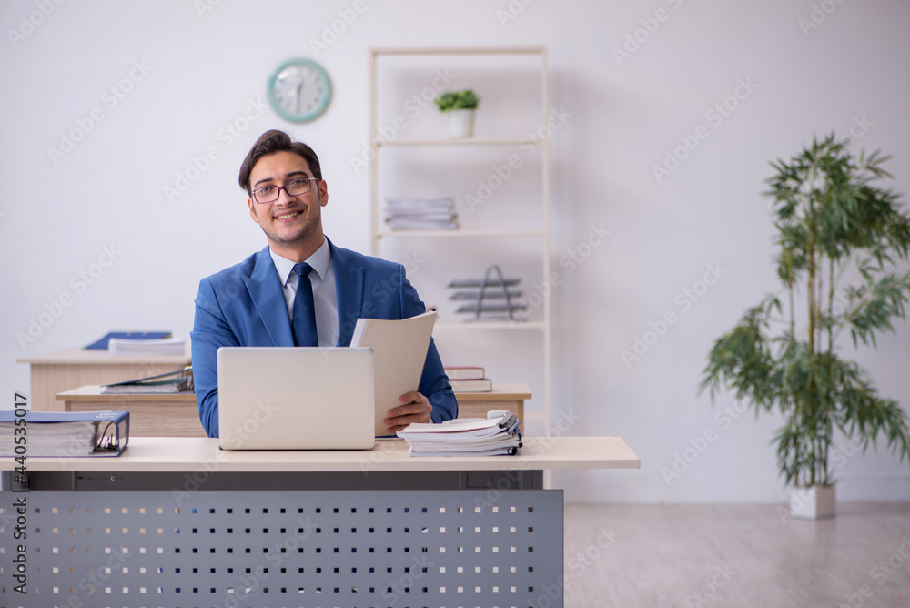 Young male employee sitting in the office Young male employee sitting in the office