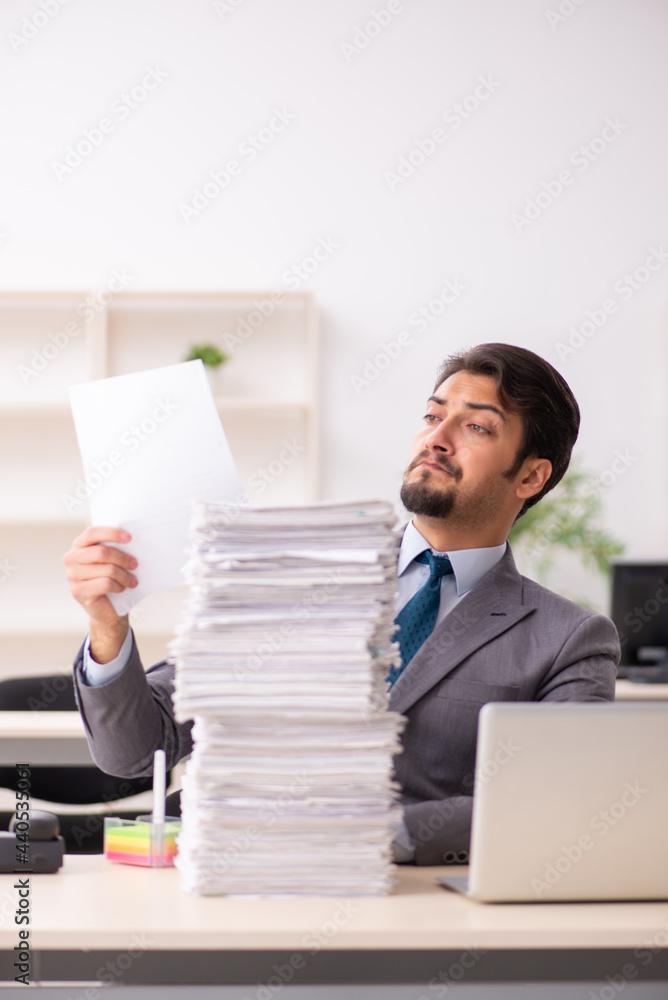 Young male employee working in the office Young male employee working in the office