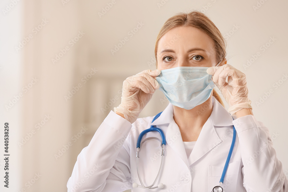 Portrait of female doctor with protective mask in clinic