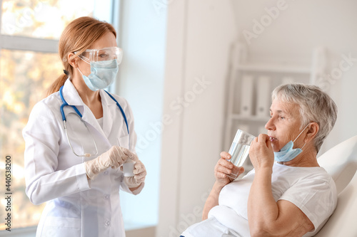 Doctor giving remedy to sen...