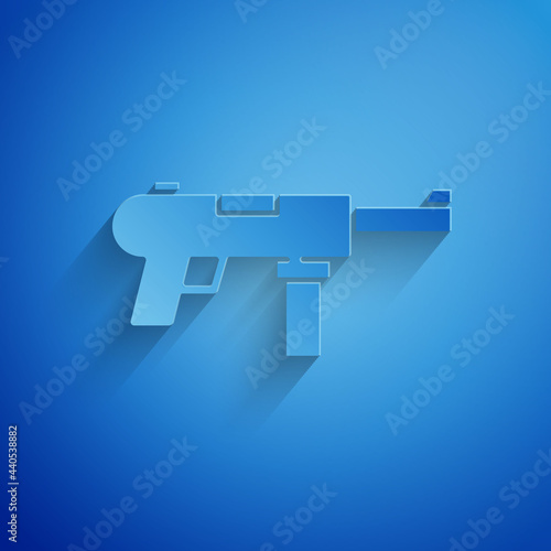Paper cut Submachine gun M3, Grease gun icon isolated on blue background. Paper art style. Vector
