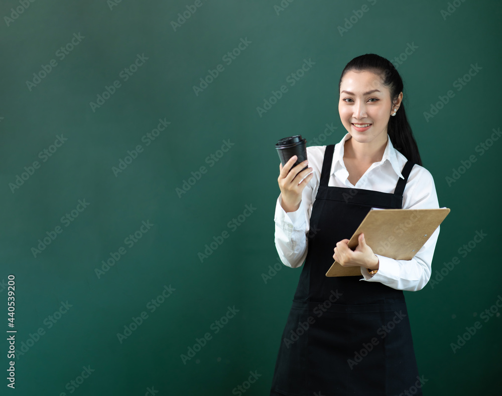 Portrait Beautiful female barista working in coffee shop. Young small business owner isolated over green background Portrait Beautiful female barista working in coffee shop. Young small business owner isolated over green background