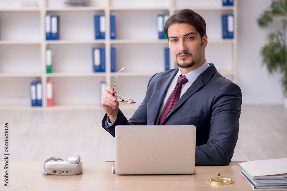 Young male employee working in the office Young male employee working in the office