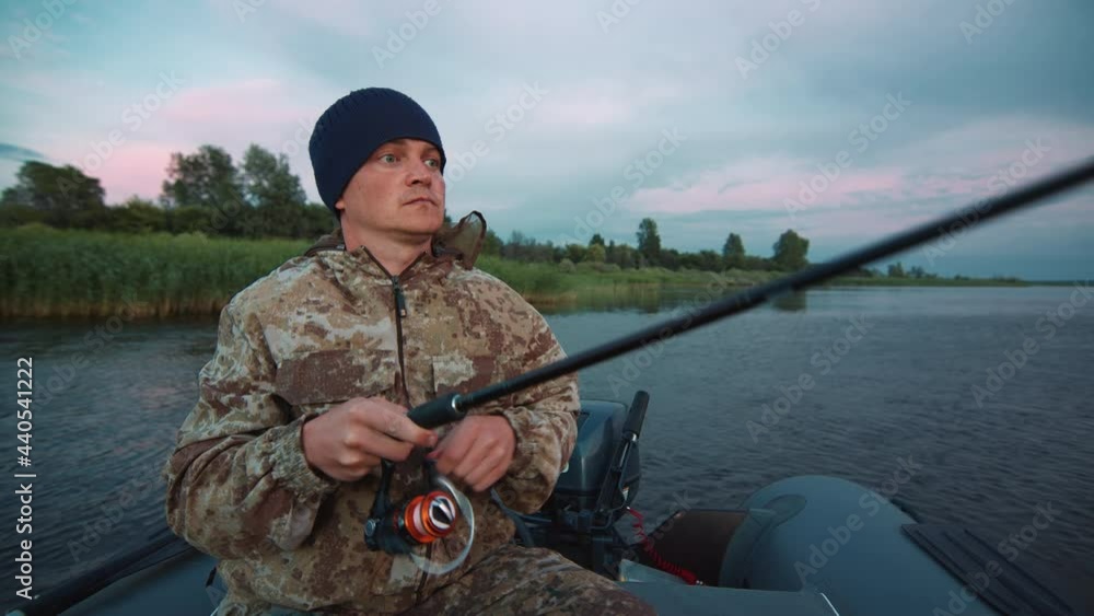 Man fishing from boat. Young amateur angler fishing from the boat at ...