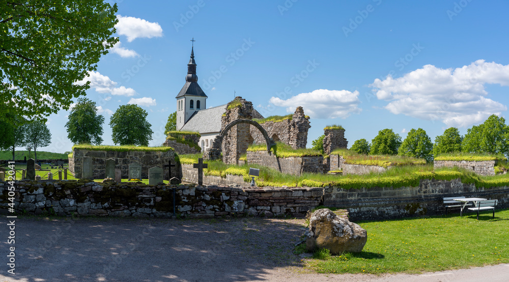 Gudhem Historical Monastery Ruin and Church with overgrown stone wall and arches