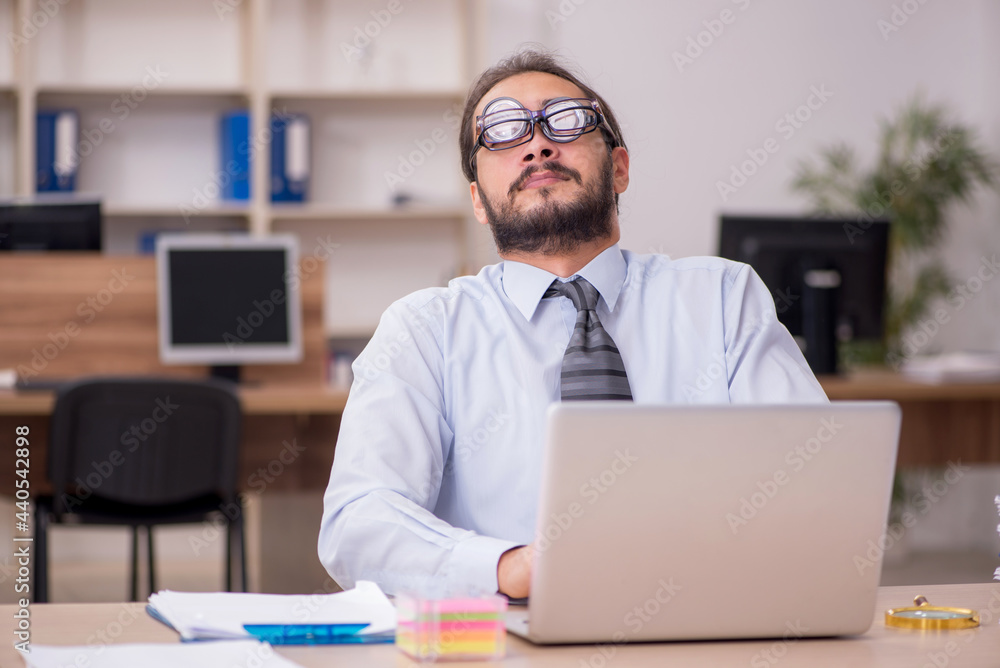 Young funny businessman employee working at workplace Young funny businessman employee working at workplace