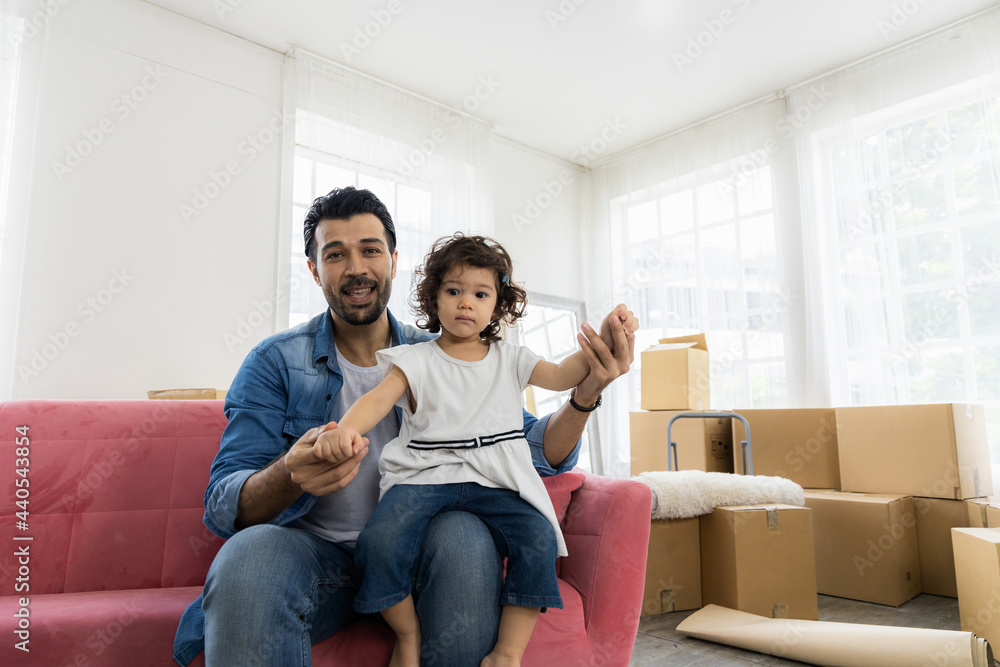 Happy family moment in the house. Father and daughter relaxing on red sofa. The family just moving in new house. Happy family moment in the house. Father and daughter relaxing on red sofa. The family just moving in new house.
