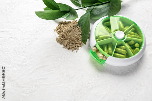 Organizer with pills on white background photo